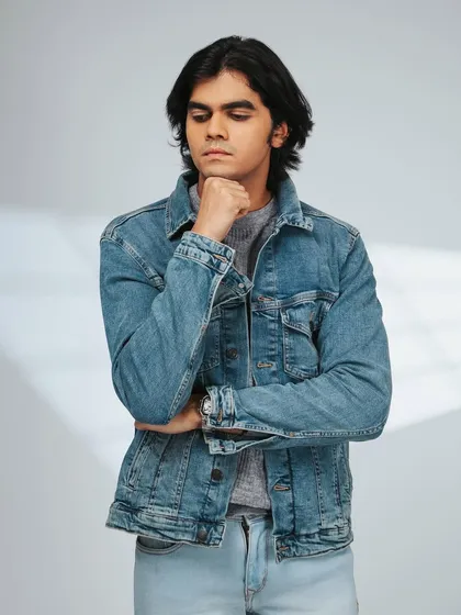 Adding a denim jacket for a layered look. The thoughtful pose adds a bit of character.