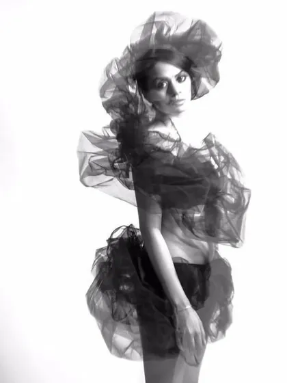Another perspective of the monochrome sheer drape. This view highlights the garment's volume and movement, demonstrating how different angles can tell a different story in a fashion photoshoot.