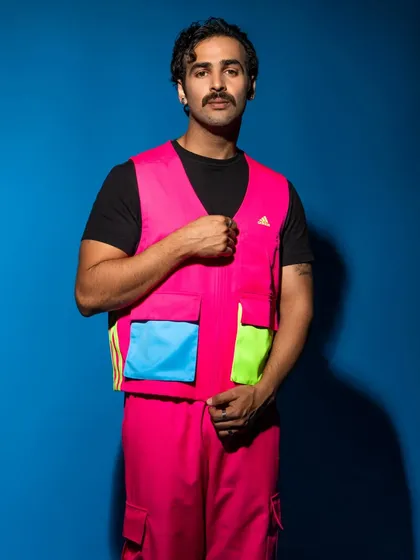This shot highlights the utilitarian details of the outfit, like the multiple pockets, while maintaining a strong fashion-forward feel.