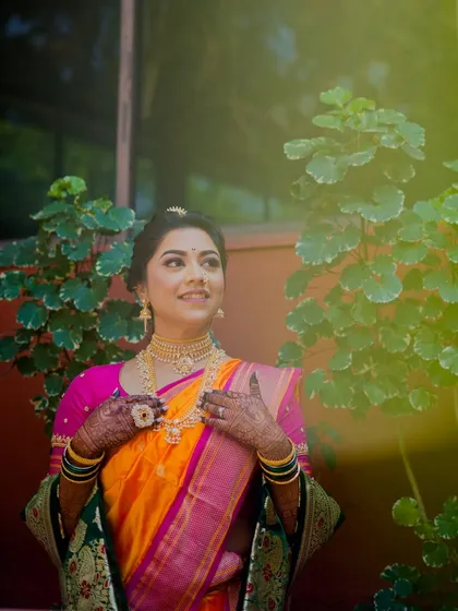 Sneha's radiant smile during her wedding. The clean skin look and bold glittery eyes she requested are on full display.