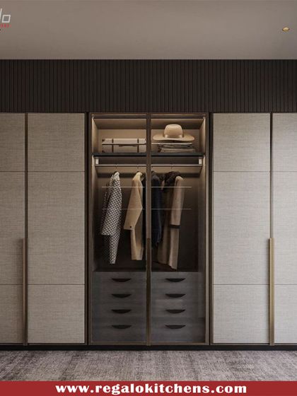 This wardrobe uses textured grey panels and slim, vertical handles to create a sophisticated and contemporary look. A central glass section breaks up the solid fronts.