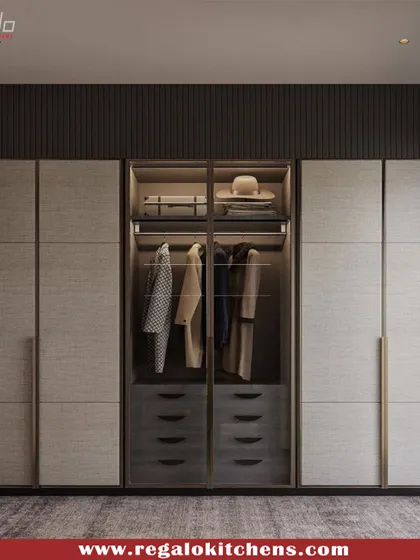 This wardrobe uses textured grey panels and slim, vertical handles to create a sophisticated and contemporary look. A central glass section breaks up the solid fronts.