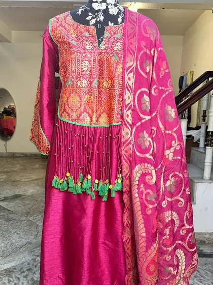 The full view of the magenta suit set with its beautiful banarasi dupatta.