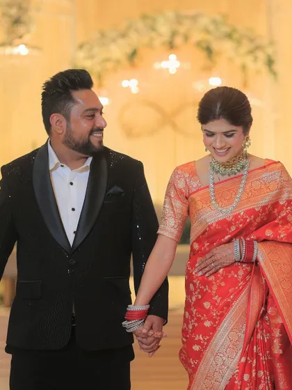 A sweet, smiling moment between the couple. The bride's makeup is soft and romantic, enhancing her natural beauty.