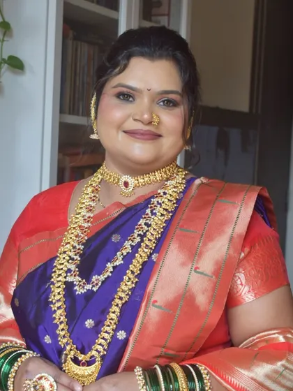 A classic portrait of a Maharashtrian bride, looking radiant in a Paithani saree with heavy traditional jewelry.