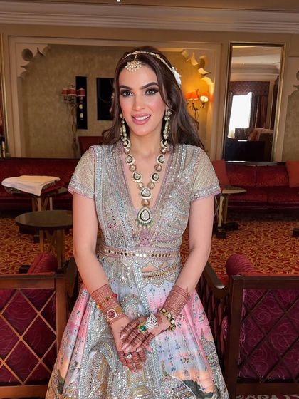 The bride looking radiant and happy with her floral half-up hairstyle for her destination wedding.