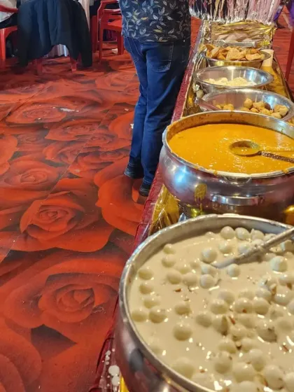 A buffet counter featuring our popular desserts, including Rasgulla with Rabdi, a sweet and creamy delight for guests.
