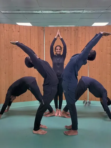 A creative and symbolic yoga pose performed by my athletes, showcasing teamwork and balance. This reflects the holistic and connected culture I foster at the club.