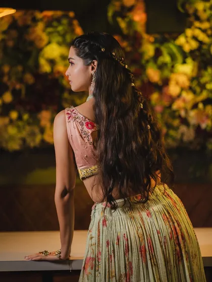 A view of the romantic, half-up hairstyle that perfectly complements the soft and pretty makeup.