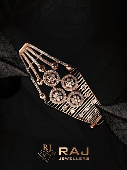This wide bracelet features a unique design with four floral motifs and dangling elements. The combination of textures and sparkle makes it a truly distinctive piece of wristwear.
