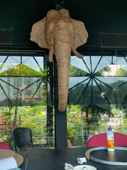 The finished cardboard elephant head, now a permanent resident at our studio. This piece has traveled to several events and serves as a great example of a reusable, high-impact installation for any occasion.