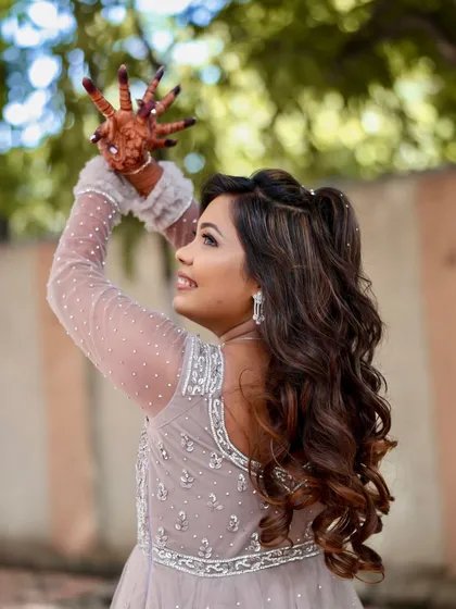 A playful shot showing the bride's happy energy. The makeup is designed to be fun and celebratory, just like the occasion.