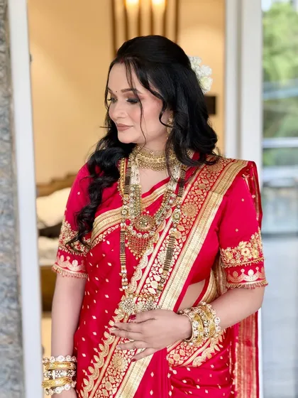 A side profile revealing the beautiful hairstyle with a fresh gajra, a classic choice for traditional Maharashtrian events.