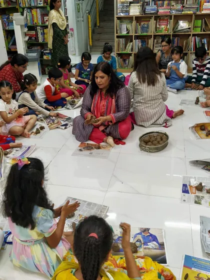 It's not just about listening to stories; it's about creating them too. Here, I'm guiding children as they make their own clay Ganeshas during our 'Ganpati ki Gaathayein' workshop. This hands-on activity helps them connect with the story on a deeper, more personal level.