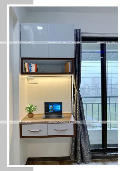 A compact study unit perfect for a small bedroom or a corner of the living room. The wall-mounted design keeps the floor clear, and the overhead cabinets provide storage for books and stationery.