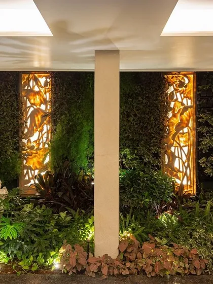 An example of a small-scale interior plant installation. We created a focal point in this niche using a dense green wall, layered undergrowth, and two backlit art panels, demonstrating how even small corners can become powerful design statements.