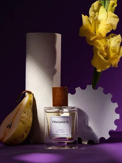 A still life composition blending product photography with art. We used the perfume's key ingredients, like pear and yellow flowers, alongside abstract props to create a visually interesting and modern shot against a deep purple background.