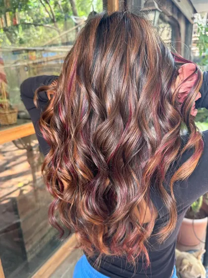Kicking summer to the curb with this fresh cut and color. A beautiful blend of caramel and red peekaboo highlights on a brown base, all done without bleach.