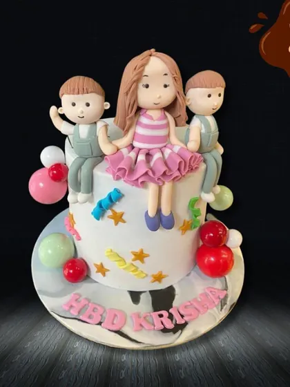 A sweet cake celebrating friendship and family. This design features three cute, personalized figures sitting together on top of a star-decorated cake.