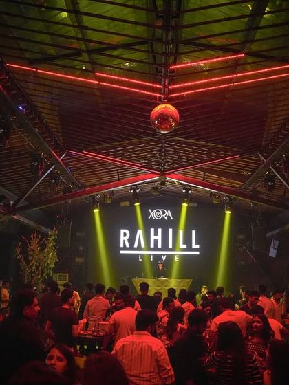 A wide shot of the club, showing the architecture and the packed dance floor. I select venues that are not only premium but also visually interesting, adding to the overall experience.