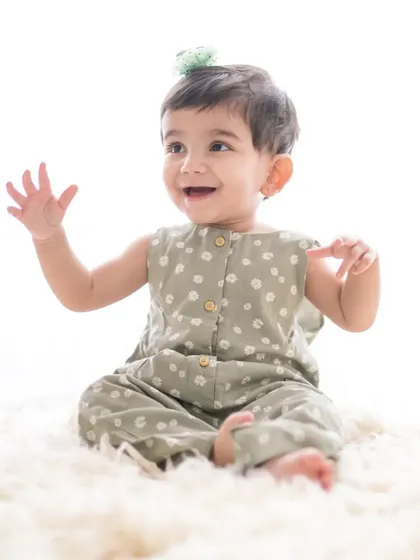 A simple, joyful portrait of a baby girl on a soft, fluffy rug. The clean, bright background and her happy expression make for a beautiful and timeless image.
