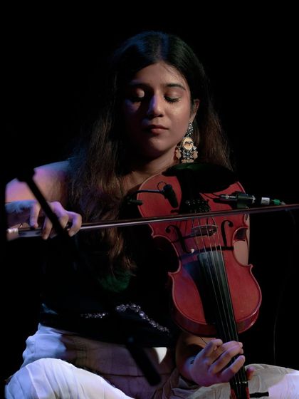 A close-up of Apoorva Krishna's intense focus during a concert in Delhi. She is a powerhouse of talent and grace on stage.