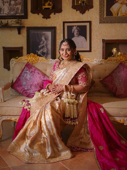 A smiling portrait of the mother-to-be, looking radiant in her traditional attire and our florals.