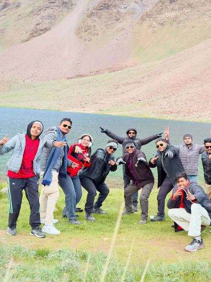 The group enjoying a fun, relaxed moment together by the lake. These trips are as much about the people you meet as the places you see.