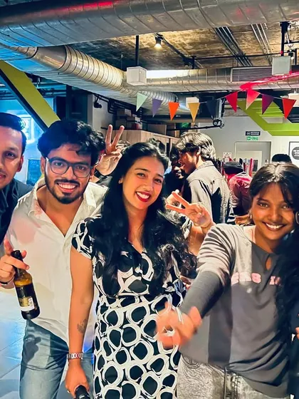 A group of friends enjoying drinks and getting ready for their turn at the mic. The perfect start to a weekend.