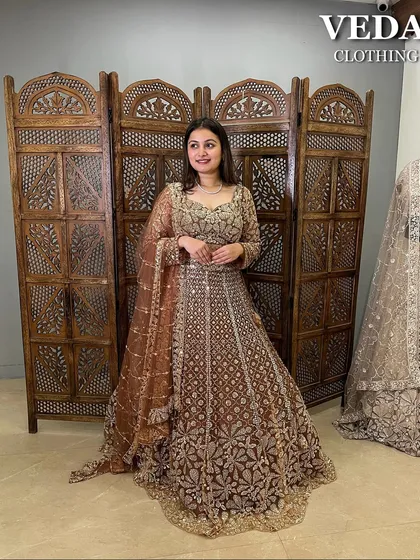 A full shot showing the beautiful A-line silhouette and the detailed work that covers this entire bronze lehenga.