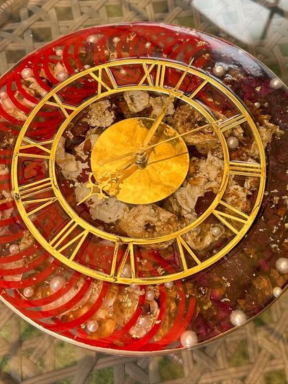 A 12-inch clock preserving a bride's chooda bangles and varmala flowers. The red bangles create a striking pattern around the clock face, making this a bold and beautiful wedding keepsake.