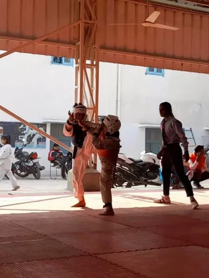 Another action shot of Rachna Kumari, demonstrating excellent form and extension in her kicking technique during a sparring session.