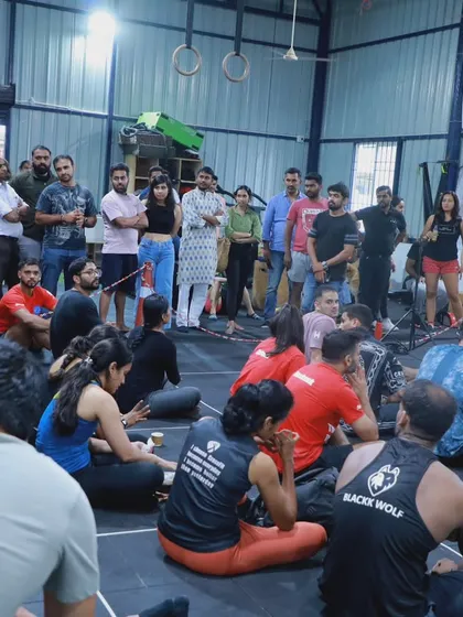 Athletes and spectators gather for a workout briefing. The entire community gets involved, creating an electric atmosphere.