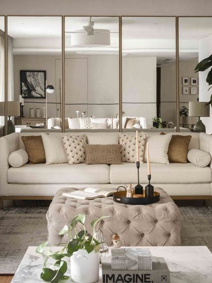 A closer look at the sofa against the mirrored wall, showing how we use reflective surfaces to enhance light and create a sense of spaciousness.