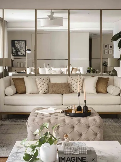 A closer look at the sofa against the mirrored wall, showing how we use reflective surfaces to enhance light and create a sense of spaciousness.