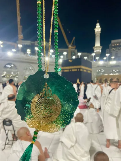 A luxurious car hanging in an emerald green and gold design, featuring Ayat ul Kursi. It's paired with a matching crystal tasbeeh, making it a beautiful spiritual accessory for your vehicle.
