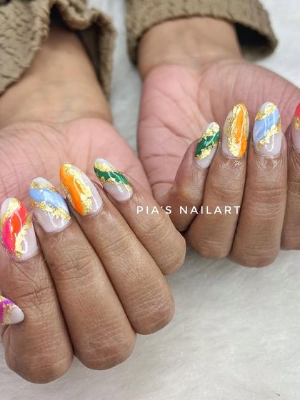 Advanced marble art with a rainbow of colors and gold foil flakes. This technique creates a unique, stone-like effect on every nail.