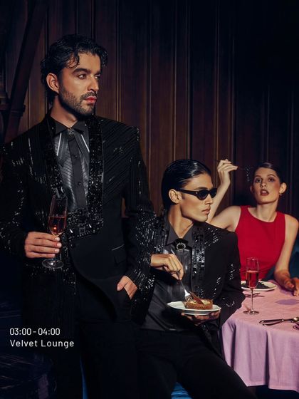 A scene from the Velvet Lounge. The men, dressed in my black sequined suits, command the table. Their presence is the main event.