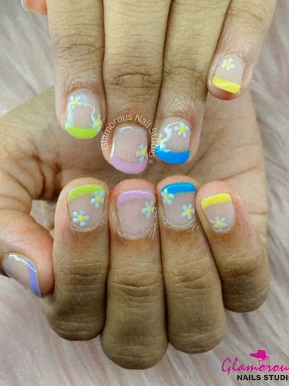 Perfect for summer, this design features a rainbow of pastel-colored French tips, each decorated with small, hand-painted white daisies.