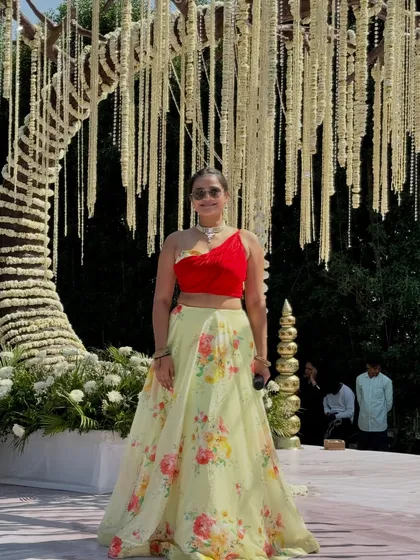 A closer look at my outfit for the daytime wedding function, with the intricate floral backdrop.