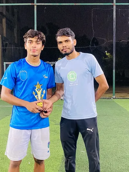 A coach poses with one of the best performers from the youth league trials. I ensure that every player gets a fair chance to demonstrate their abilities and receive constructive feedback.
