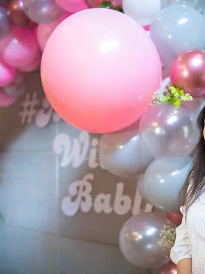Posing in front of a balloon and flower arch I designed for a baby shower. I love mixing mediums like balloons and fresh flowers to create fun, modern decor for personal celebrations.