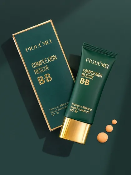 A luxurious flatlay for a BB cream, shot on a rich, dark green background. We used soft, directional light to create leafy shadows, adding a touch of nature and elegance while highlighting the product's gold accents.