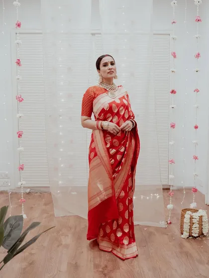 For this project, I recreated Anushka Sharma's iconic wedding reception look, featuring a classic center-parted sleek bun and a traditional red saree.