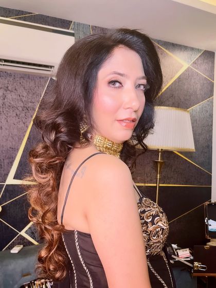 A beautiful side profile, highlighting the sultry eye makeup and the glowing skin of this party look.