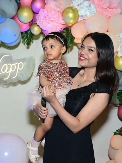 A mother and her baby girl enjoying the beautiful tropical-themed party we designed.