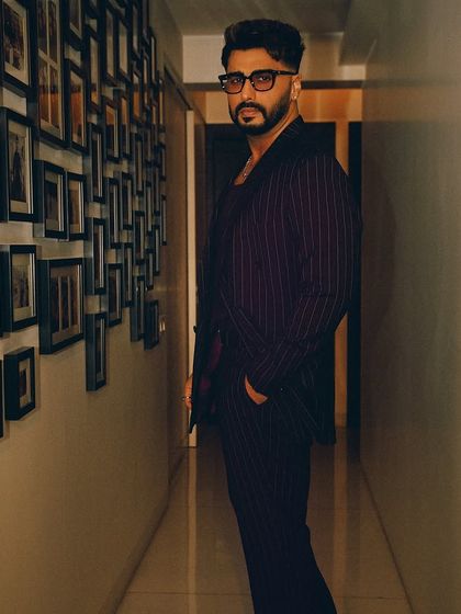 A final shot of Arjun Kapoor's premiere look. This angle shows the structure and fit of the double-breasted suit jacket, a key element of this modern menswear styling project.
