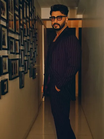 A final shot of Arjun Kapoor's premiere look. This angle shows the structure and fit of the double-breasted suit jacket, a key element of this modern menswear styling project.