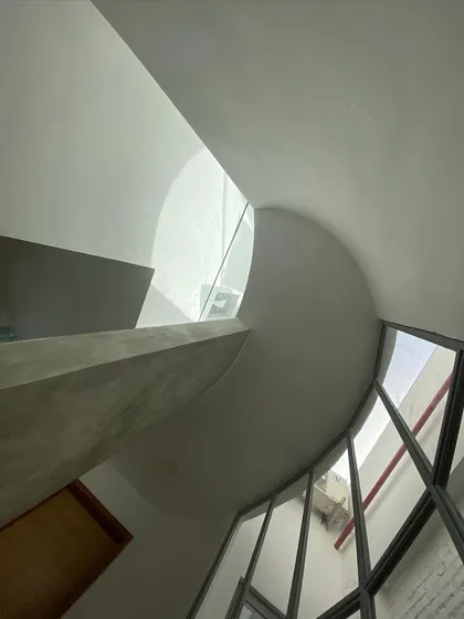 Light is a building material. This sculpted, non-rectilinear skylight is designed to do more than just illuminate; it channels sunlight, creating dynamic patterns of light and shadow that change throughout the day, turning the space into a living sundial.