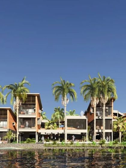 This rendering shows the retreat from the river side, with the architecture nestled amongst palm trees, creating a serene, tropical atmosphere.